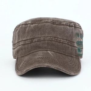 Detailed close-up of distressed brown cotton military cap with side letter embroidery