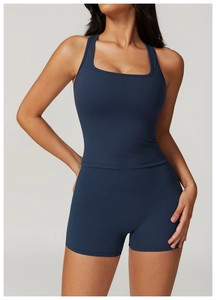 Detail of navy blue racerback sports top and high waist shorts with sleek fabric texture