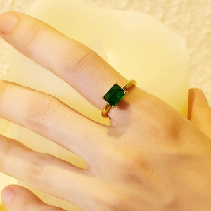 Close-up of 18K gold-plated ring featuring a rectangle emerald green zircon on hand