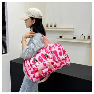 Detail of pink floral gym bag with wet/dry separation and durable woven handles