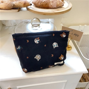 Close-up of black canvas pouch featuring cute cat embroidery and Sozakka label