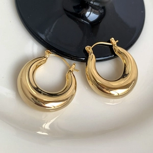 Chic polished gold round metal hoop earrings with a sleek minimalist drop design