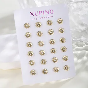 Detailed set of 12 pairs of golden daisy stud earrings with white crystals on a card