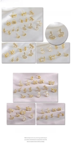 Detailed view of gold animal earrings with crabs and cats set with sparkling crystals