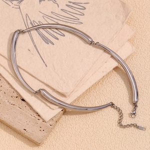 Detailed close-up of silver bamboo link chain necklace with lobster clasp on stone