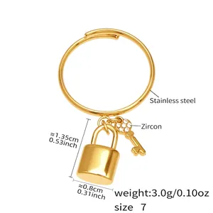 Detail of adjustable gold ring with micro-set zircon lock and key tassel charms