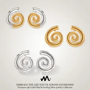 Detail of twisted hoop earrings in gold and silver finishes with high-polished texture
