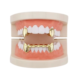 Gold vampire fangs grillz set on white teeth model for hip hop fashion style decoration