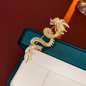 Exquisite gold-plated dragon brooch with sparkling crystals on green velvet box