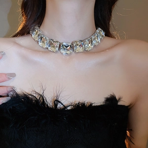 Close-up of model wearing a sparkling square crystal choker necklace in silver finish
