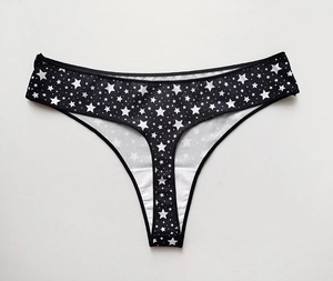 Detail eines weichen nahtlosen Thongs in Schwarz mit weißem Sternenprint und Stretch
