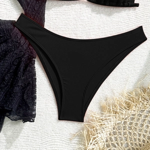 Macro shot of black ribbed lace bikini bottom featuring fine textured knit and elastic edges