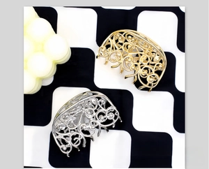 Detail view of retro baroque hollow metal hair claws in gold and silver finishes