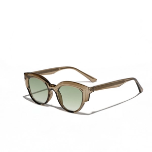 Vintage cat-eye sunglasses with amber frame and light green lenses on a white background