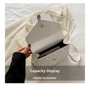 Detailed interior of a white quilted crossbody bag showing smartphone storage capacity