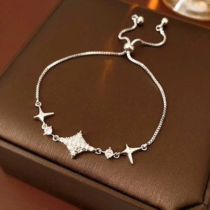 Macro shot of silver star-shaped bracelet featuring zircon inlay and adjustable slide clasp