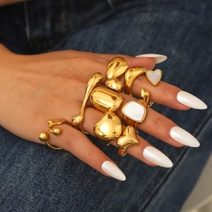 Minimalist 18K gold plated irregular geometric ring set on denim background