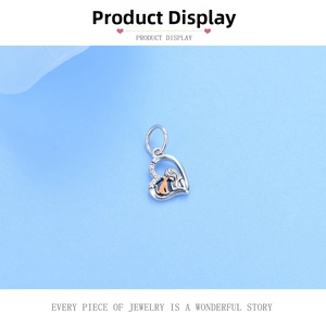 Detailed macro view of S925 sterling silver heart charm with girl and rose gold cat silhouette