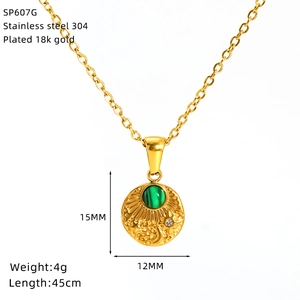 Macro view of gold stainless steel necklace with sunburst sun and moon turquoise pendant