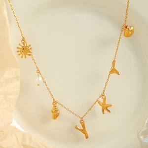 Golden ocean theme necklace with starfish shell and pearl charms on an elegant chain
