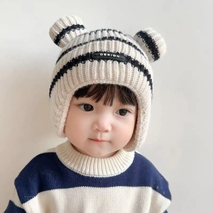 Cute baby winter knit hat with ear flaps, cream and black stripes, and double pom-poms