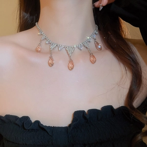 Detailed view of silver tassel necklace featuring champagne waterdrop zirconia stones