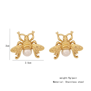 Detailed size view of gold bee earrings with white pearls and 2.5cm width specs