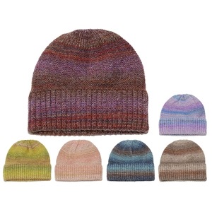 Collection of vibrant ombre gradient knit beanies showing ribbed texture and various colors