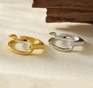 Detail showing two-tone gold and silver minimalist rings with unique link design