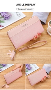 Detailed view of pink long zip wallet with glitter patchwork, wrist strap, and tassel