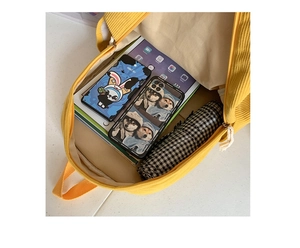 Interior view of yellow corduroy backpack showing large capacity for tablet and books