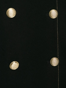 Close-up of golden embossed metal buttons on a black double-breasted suit jacket