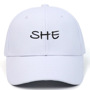 White cotton baseball cap featuring black SHE letter embroidery and a curved brim