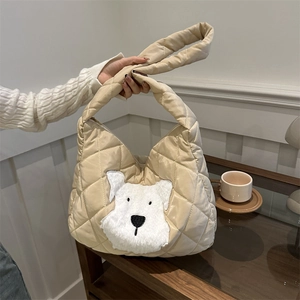 Beige quilted tote bag with cute plush dog patch and chunky handles for daily commute