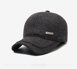 Detail of dark gray thermal baseball cap featuring textured wool and metal logo plate