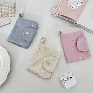 Detail of fabric card holders with star sequins, heart buttons and hanging hooks