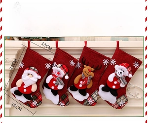 Detail of four red Christmas stockings with 3D Santa and reindeer hanging on a mantel
