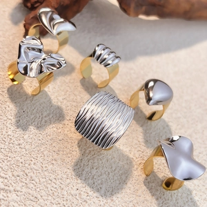 Two-tone 18k gold and silver stainless steel rings with irregular geometric design