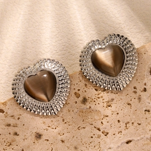 Close-up of heart-shaped tiger eye earrings with vintage silver textured edges