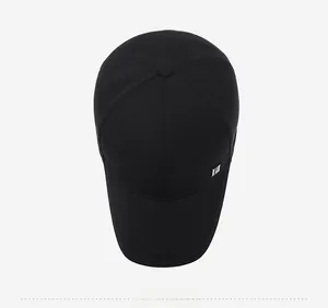 Top view of a black cotton baseball cap showing six-panel crown and silver logo