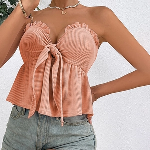 Sexy peach strapless tube top with waffle texture, bow tie, and ruffled hem details