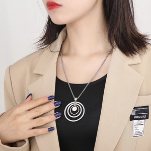 Detail of silver layered concentric circle pendant necklace on a model