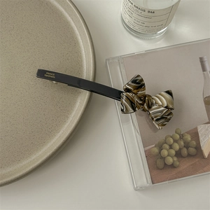 Detail of tortoise shell acetate bow hair clip with France Handmade metal clasp