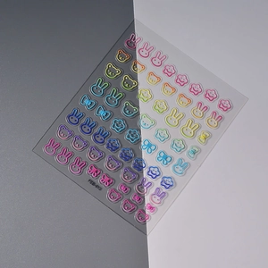 Detail view of 3D embossed cartoon nail stickers featuring macaron bear and rabbit motifs