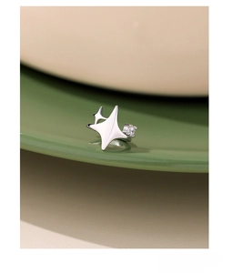 Macro shot of S925 sterling silver four-pointed star ear cuff with sparkling zircon