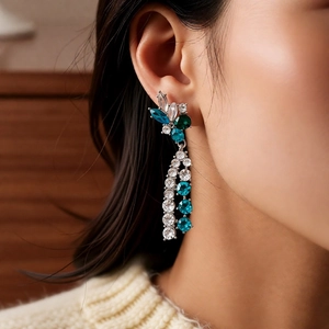 Close-up of vintage flower earrings with blue crystals and elegant silver chains