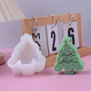 Detail of Christmas tree silicone mold with finished green handmade soap on a soft desk