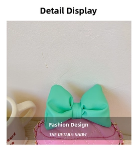 Close-up of pink quilted mini bag with a large green bow and gold chain strap detail