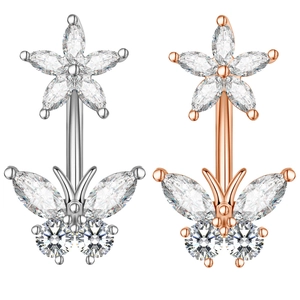 Detailed view of zircon navel rings in silver and rose gold with flower and bow designs