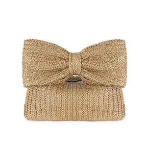 Brown straw handbag with large bow detail on white background, 2023 autumn fashion style